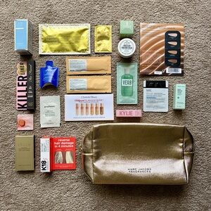 Bundle of skincare, haircare, and makeup products with travel toiletry bag